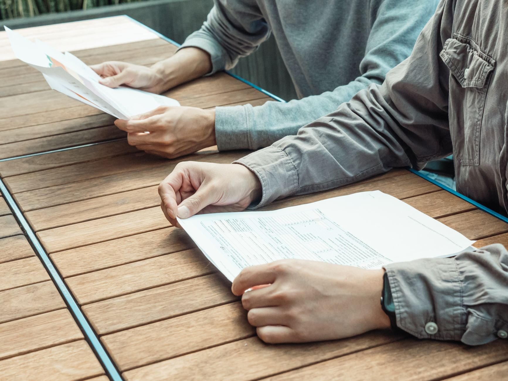 Two professionals reviewing written documents and reports together