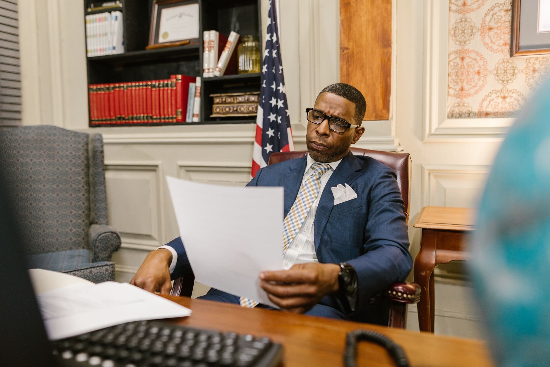 A professional advisor reviewing documents, representing independent expert analysis